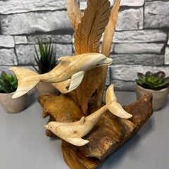 Wood Dolphins On Log