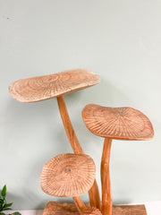 4 Wooden Carved Mushrooms on Wood Log
