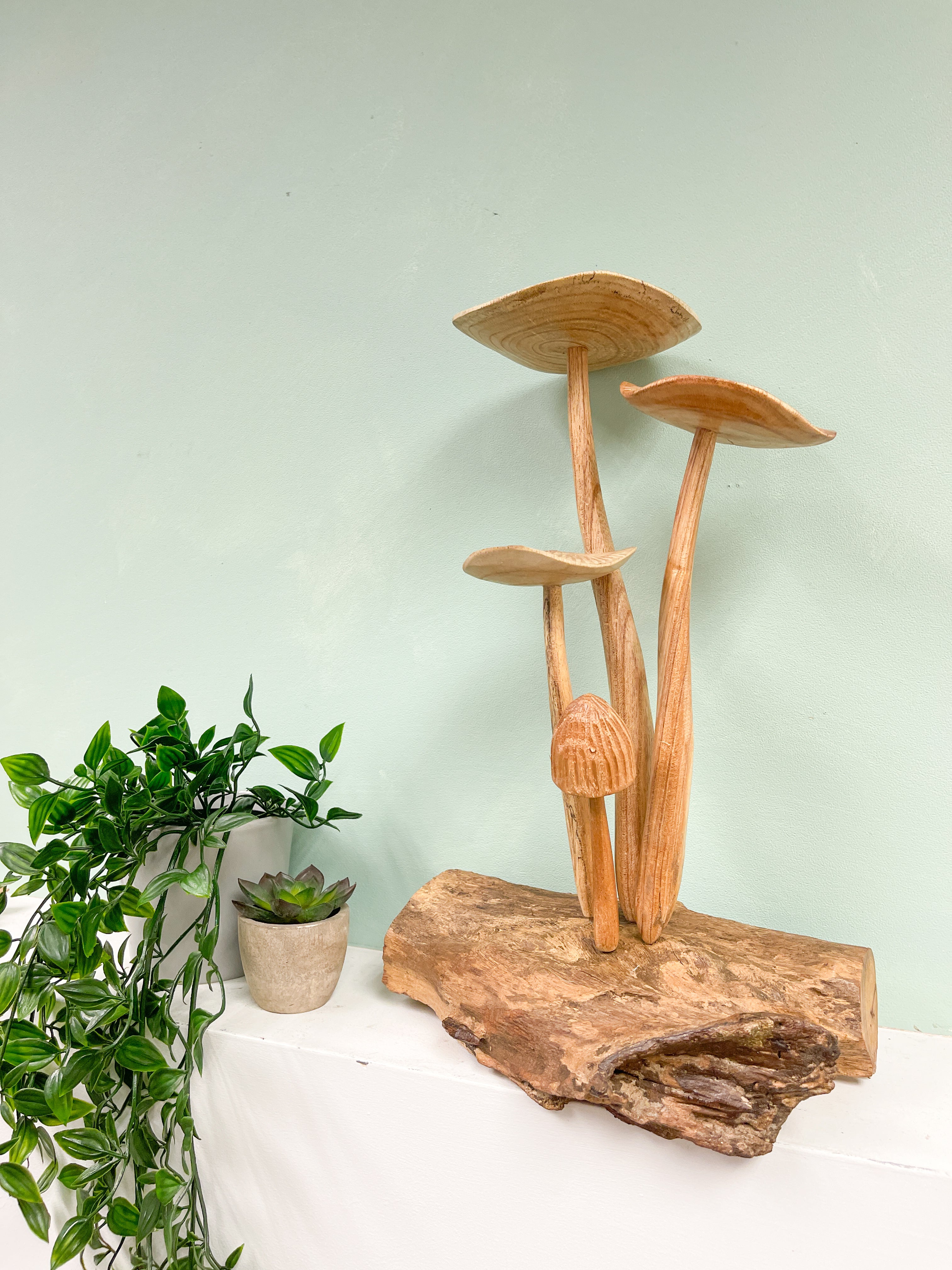 4 Wooden Carved Mushrooms on Wood Log
